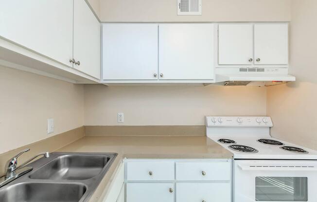 a stove top oven sitting inside of a kitchen