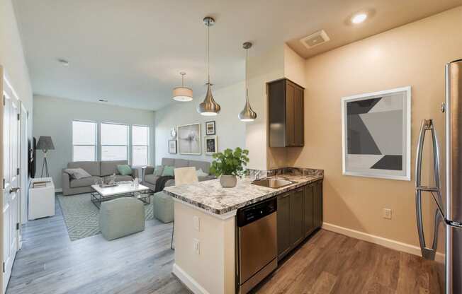 kitchen with stainless steel appliances, and view of living area with large windows at at city view apartments in washington dc