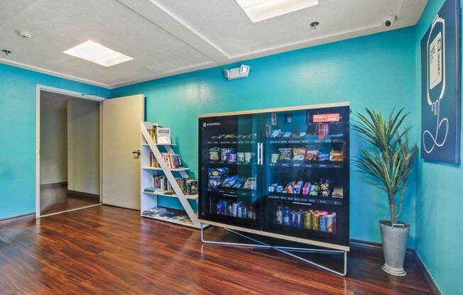 a room with a large screen tv and a bookshelf  at Masselin Park West, Los Angeles