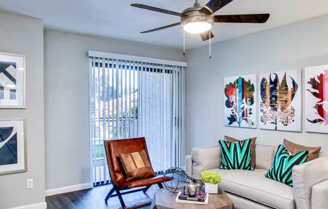 a living room with a couch chair coffee table and ceiling fanat The Julia, Mesa, AZ