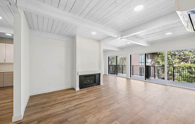 A spacious living room with a fireplace and sliding glass doors.