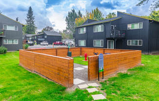 a wooden privacy fence with a fire hydrant in the background