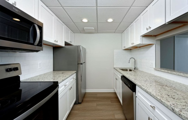 Renovated kitchen with granite countertops and stainless steel appliances at Lenox Club, Arlington, VA, 22202