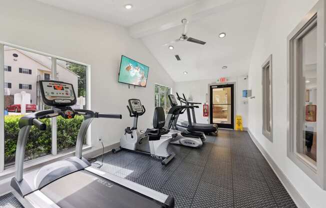 A fitness center with treadmills and ellipticals at Gwinnett Square Apartments in Duluth, GA