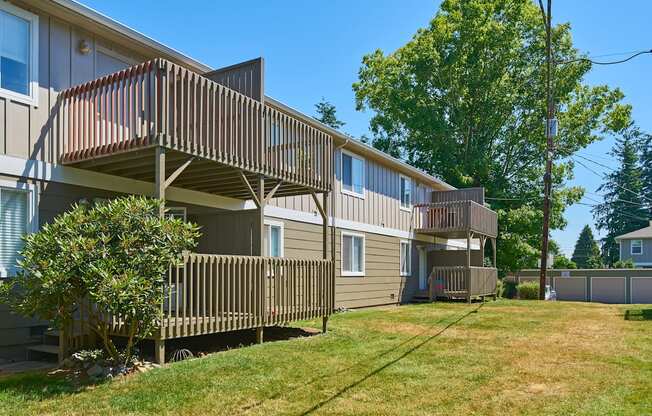 the back of two houses with balconies and a grass yard  at Woodhaven, Washington, 98203