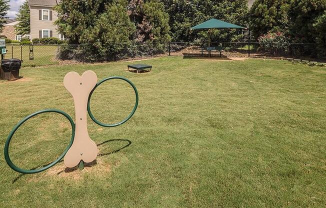 a park with a tennis racket and a hoop at Bedford Parke Apartments, Warner Robins, GA 31088