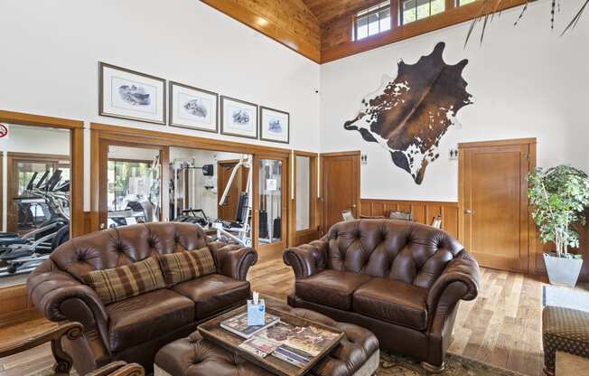 a large living room with leather couches and a coffee table