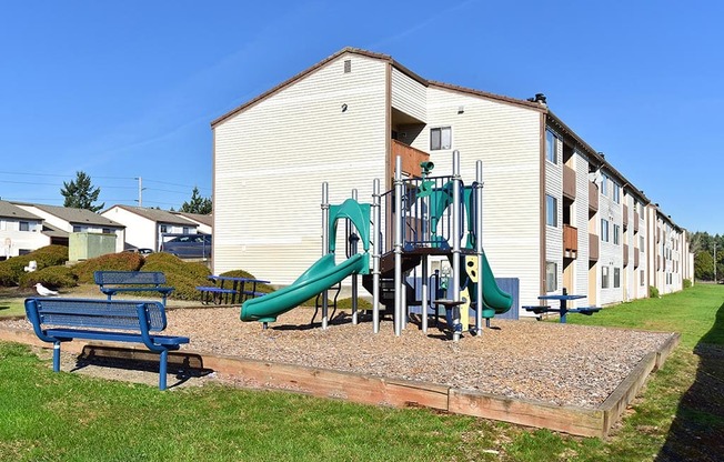 a playground in front of an apartment building