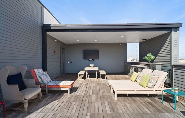 a patio with furniture and a tv on the wall