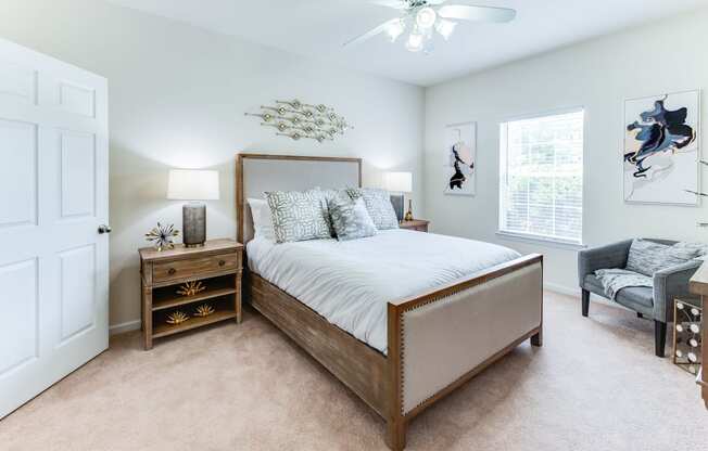 a bedroom with a large bed and a ceiling fan