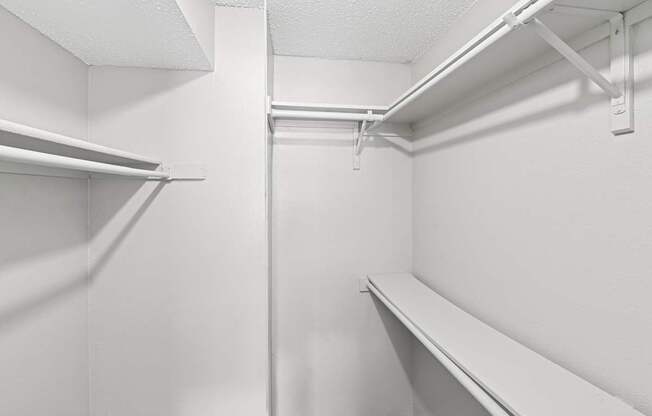 Empty white shelves in a storage room.
