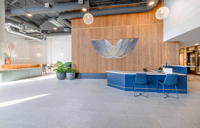 a large open office space with a wooden wall and a blue desk with blue chairs at Marina Square, Bremerton, WA