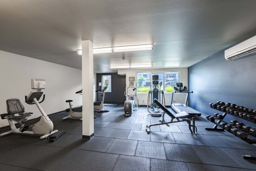 a gym with various exercise equipment and weights