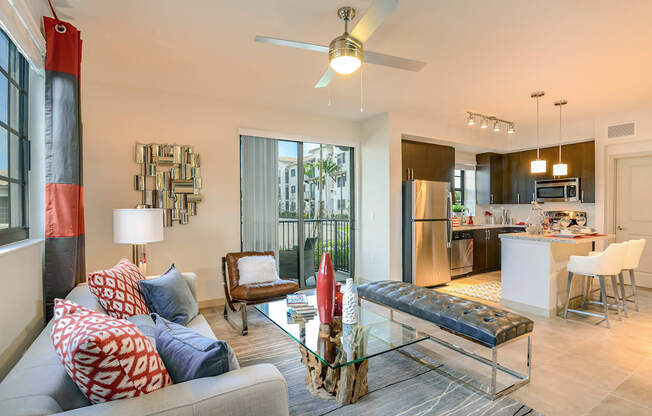 Living room with a ceiling fan at Palm Ranch Apartments in Davie, FL