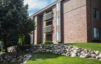 Exterior building with trees in courtyard at Dover Hills Apartments in Kalamazoo, MI