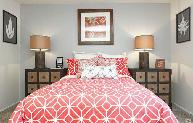 a bedroom with a bed with a red and white comforter