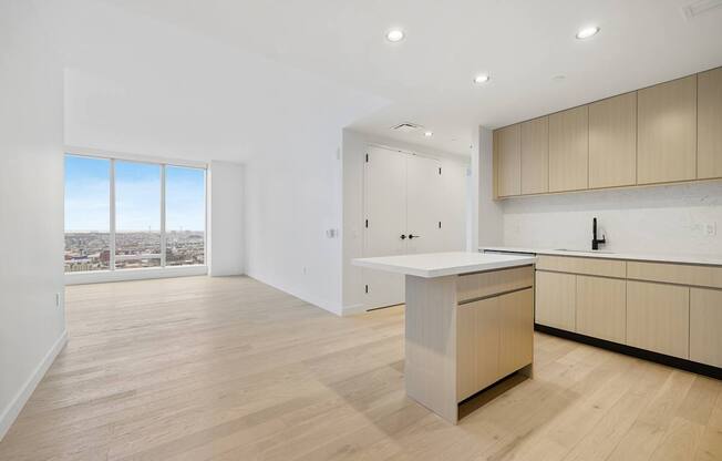 a living room with a kitchen and a window at The Paxton, Brooklyn, New York