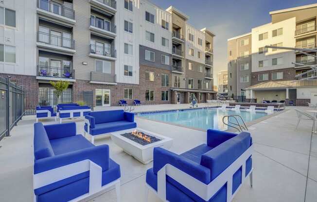 our apartments offer a pool and lounge area with blue furniture