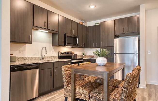 A modern kitchen with a dining table and chairs.