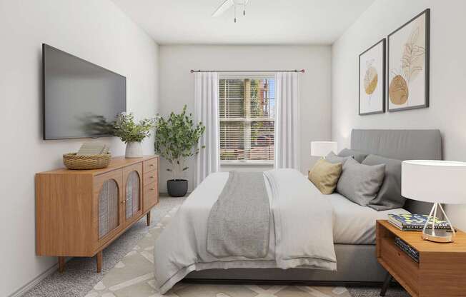 A bedroom with a bed, nightstand, and a television on the wall.