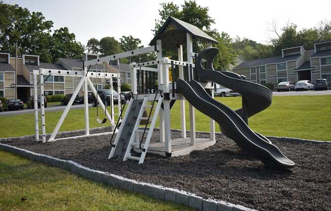 a playground with a slide in a park