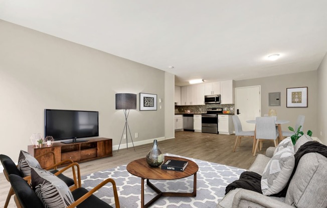 Living room, dining area and an open kitchen with wood-style floors throughout