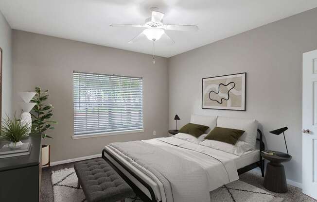 A bedroom with a bed, chair, and ceiling fan.