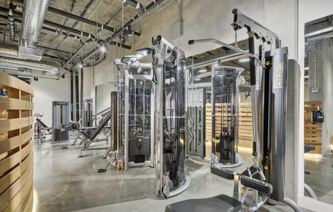 a gym with cardio machines and other equipment in a building at L Seven, San Francisco