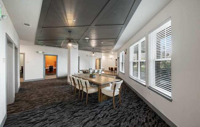 A conference room with a long table and chairs.
