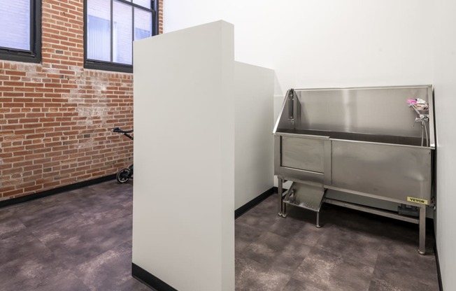 a refrigerator freezer sitting in a room next to a sink at The Draper, Missouri, 63103