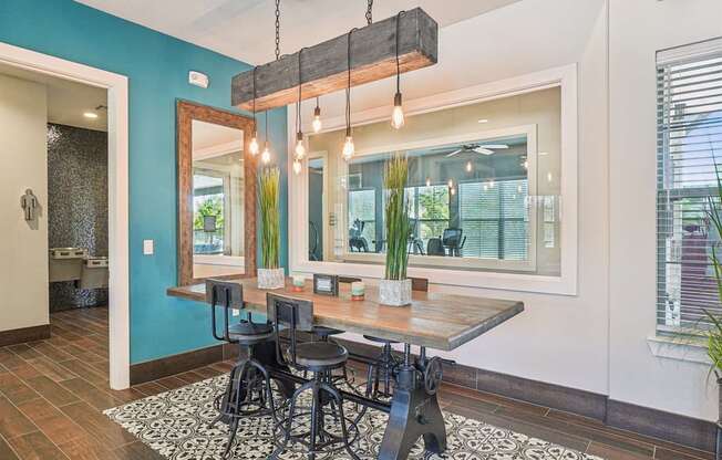A dining room with a wooden table and chairs.