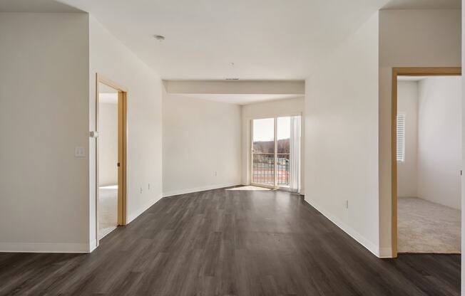 Open living room with hardwood flooring, white walls and filled with natural light.at Shoreline Village, Richland, WA
