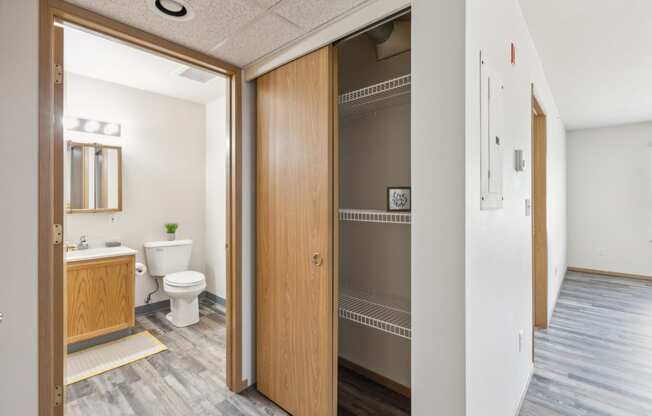 a bathroom with a toilet and a wooden door