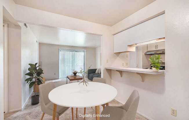 A dining room with a white table and chairs and a breakfast bar at Irish Hills Apartments, South Bend, Indiana