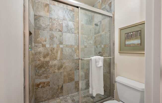 a bathroom with a shower and a white towel in it