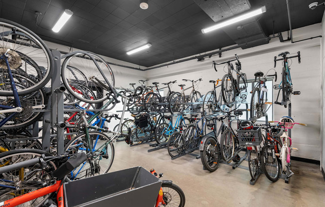 a bunch of bikes are hanging up in a bike shop