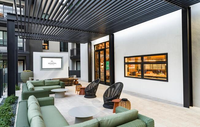 Shaded courtyard lounge at Modera Higley Commons, offering a polished place to gather just moments from Gilbert’s dining, retail, and entertainment.