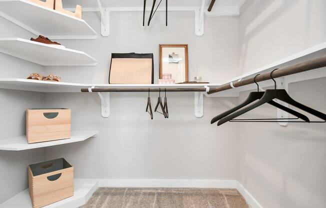 a walk in closet with a surfboard hanging on the wall