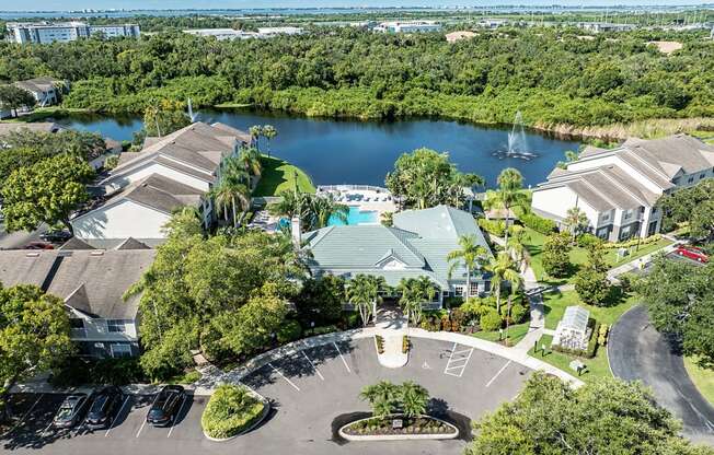 an aerial view of the resort with a lake in the background