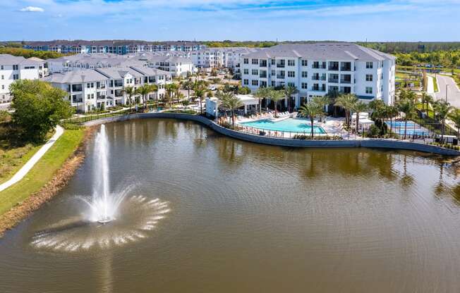 a view of a body of water with a hotel and a fountain at Altis Grand Suncoast, Land O' Lakes