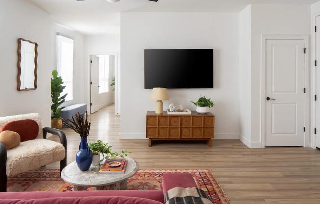 Clean lines, warm wood accents, and natural light create a living space that feels open, inviting, and effortlessly styled.