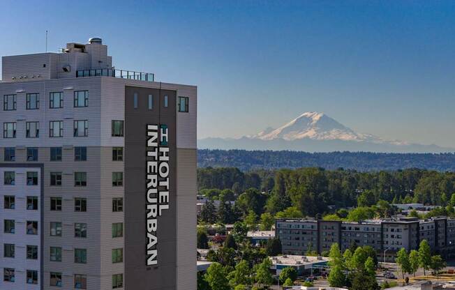 A view of a hotel with a mountain in the background.