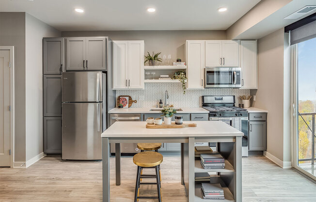 The Asher apartments kitchen with island and stainless steel appliances