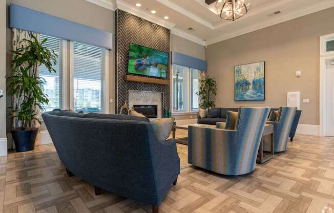 A living room with a grey sofa and a fireplace.