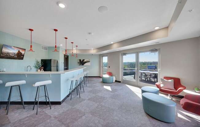 A modern bar area with a long counter and stools.