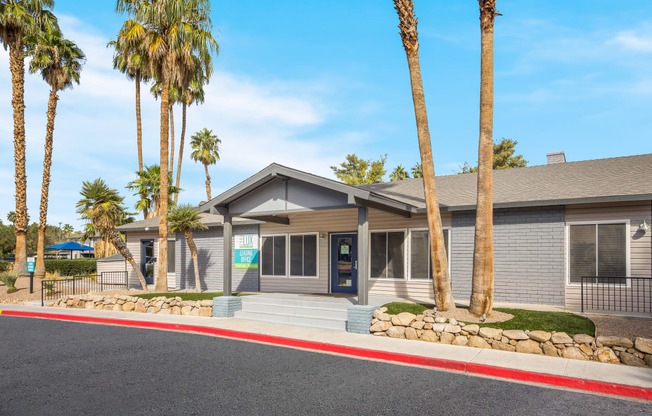 Clubhouse with palm trees in front of it at 2900 Lux Apartment Homes, Nevada