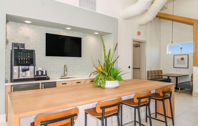 a kitchen with a large wooden table and chairs