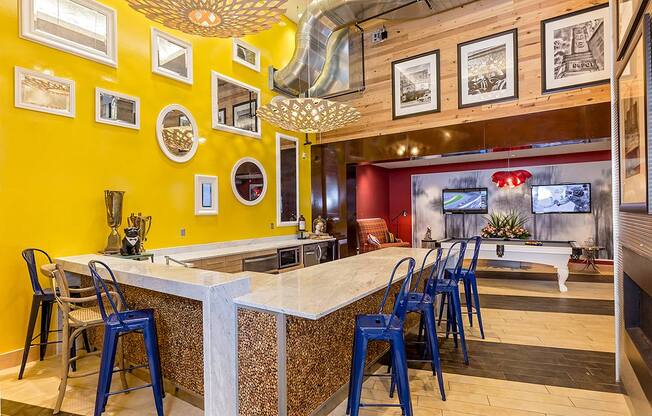 a bar with blue chairs at a restaurant with a pool table at Ann Arbor City Club, Ann Arbor, 48104