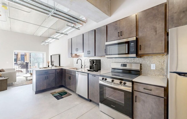 kitchen with tile backsplash, breakfast counter backed up to a living room area