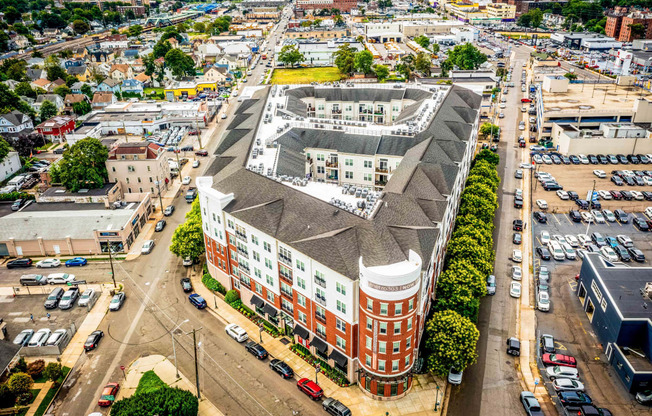 an aerial view of a large brick building with a gray roof at Metro 303, Hempstead